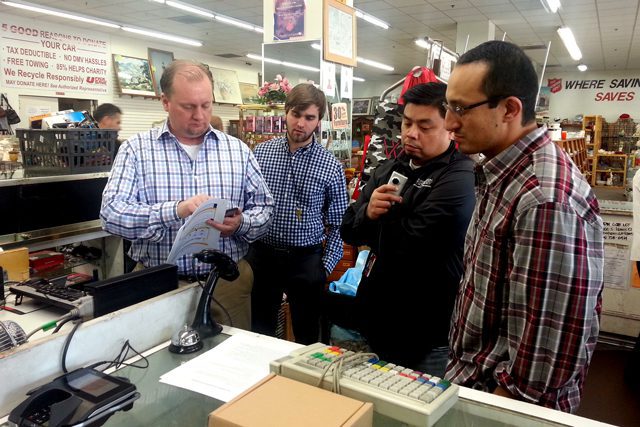 John Ickes, COO of Devnext software development firm, trains Salvation Army IT staff on how to install the MX915 tokenized credit card device.