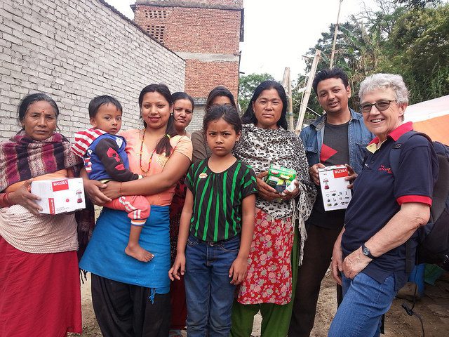 Distributing solar lamps and other essentials to members of a camp in Kathmandu