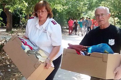 Representatives of The Salvation Army distribute supplies to refugees in Athens.