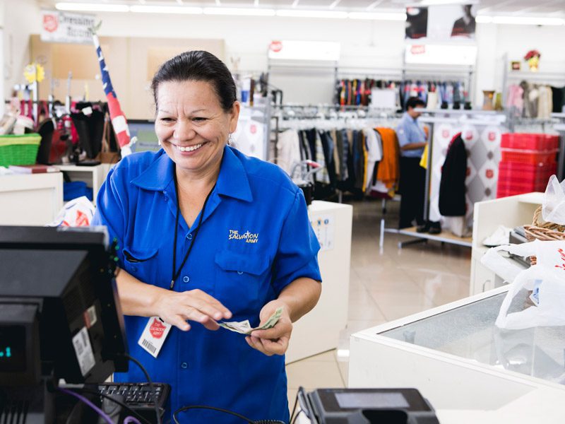 Woman smiling behind cash register