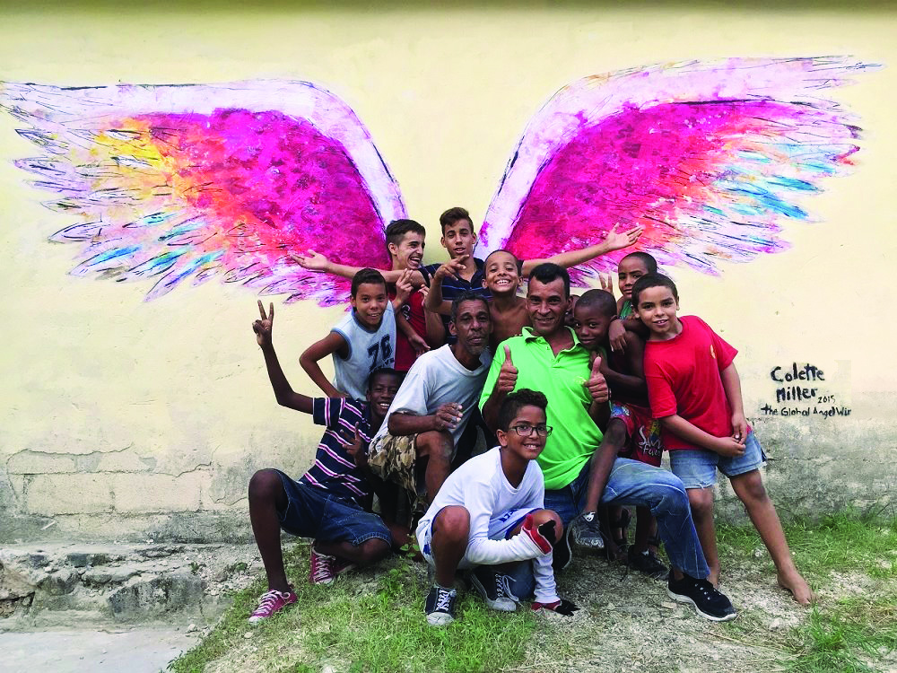 People posing in front of angel wings