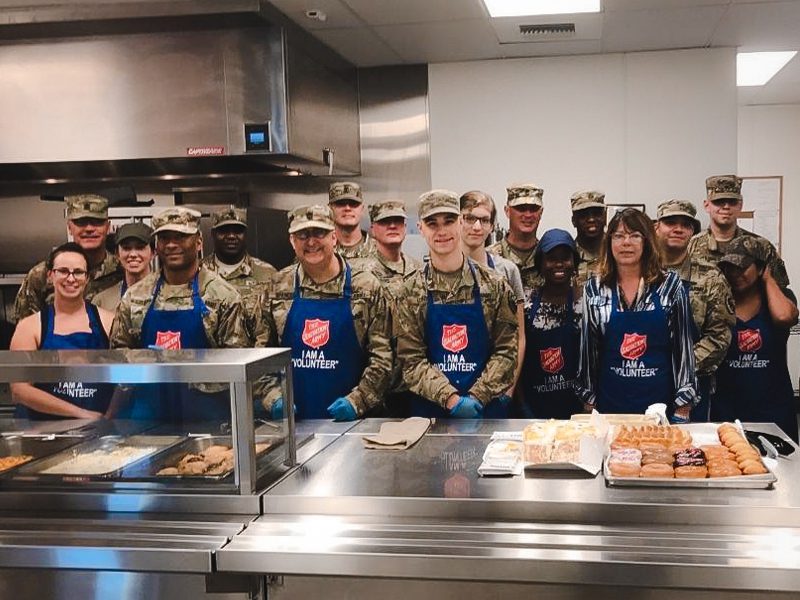 US Army personnel standing together in kitchen
