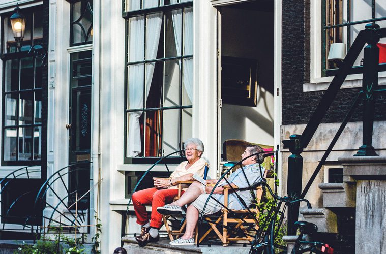 elderly couple sitting on porch