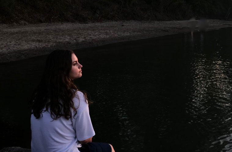 Young Woman Contemplating by Water
