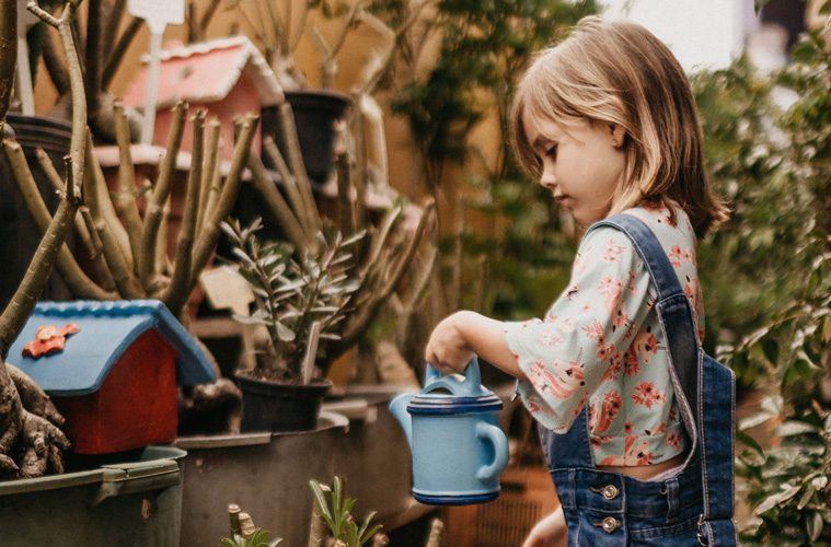 Young Girl Watering Plants