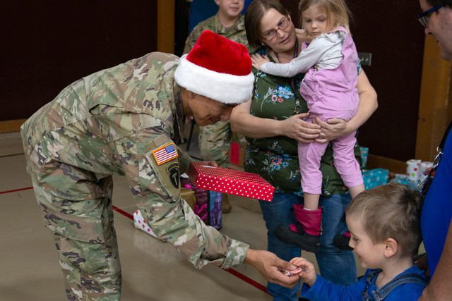 National Guard Member gives Child a toy