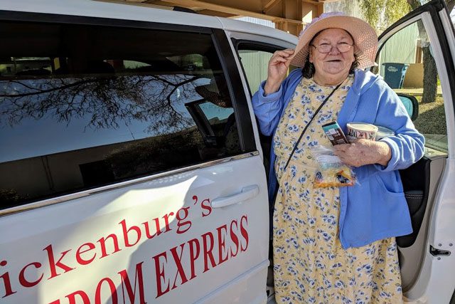 Elderly woman getting into "Freedom Express" van