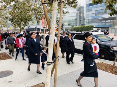 Group of Salvationists walking outside with children