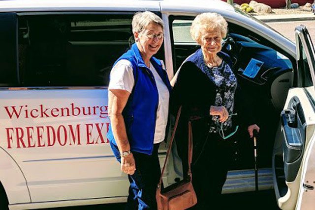 Two elderly women entering "Freedom Express" van