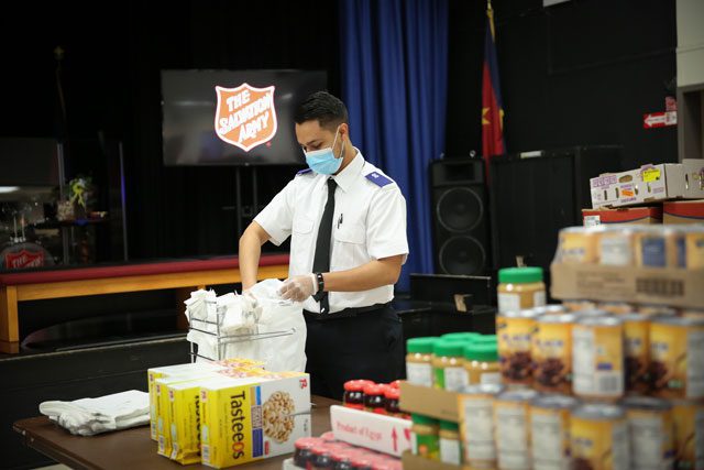 Salvation Army Officer preparing food bags