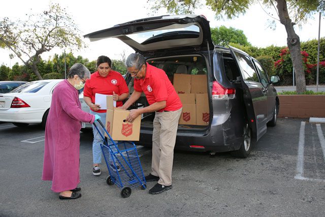 Salvationists helping elderly woman