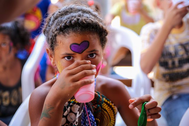 young girl drinking from cup